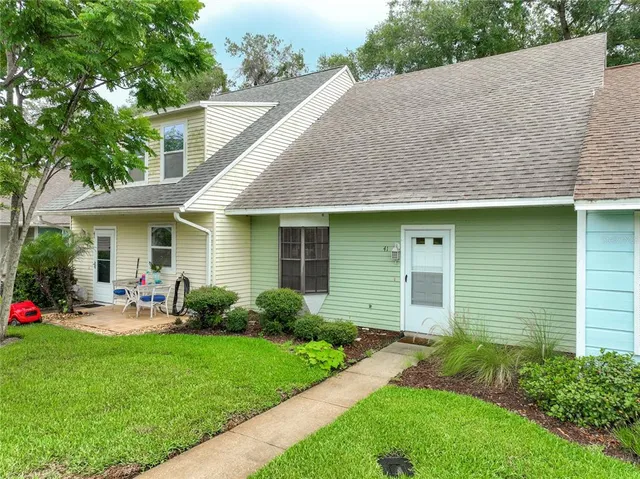 a view of a house with a yard and plants