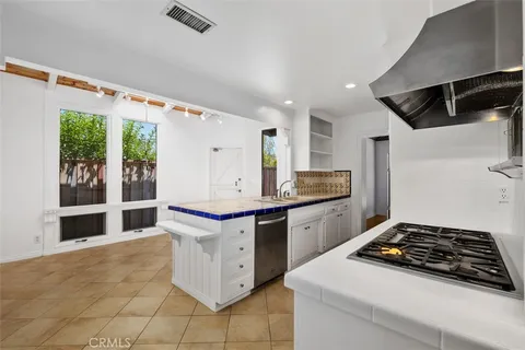 a kitchen with stainless steel appliances granite countertop a stove and a sink