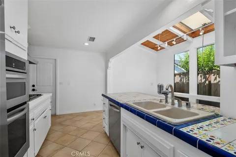a kitchen with stainless steel appliances a sink stove and cabinets