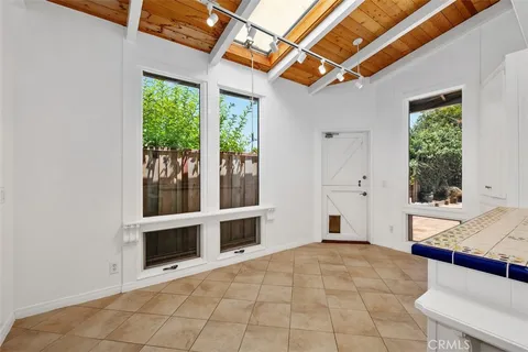 a view of an empty room with a window and fire place
