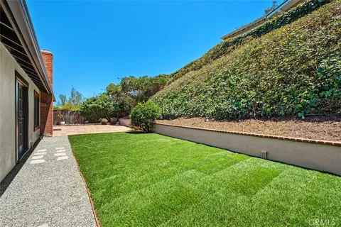 a view of a backyard with large trees