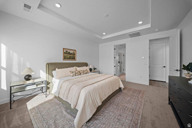 382 North Rhyolite Drive, Unit 111 Hurricane, UT 84737 - Photo 10 of 37 Recessed lighting illuminating a spacious room with a tray ceiling and plush carpet flooring
