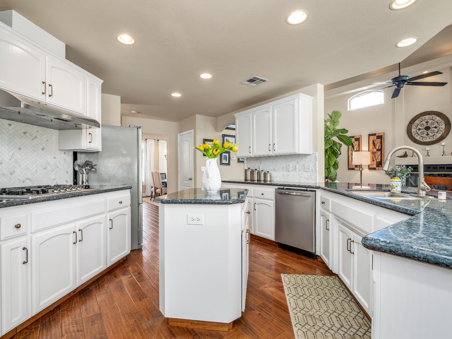 12 Breeze Way Madera, CA 93637 - Photo 12 of 48 a kitchen with granite countertop white cabinets and white appliances