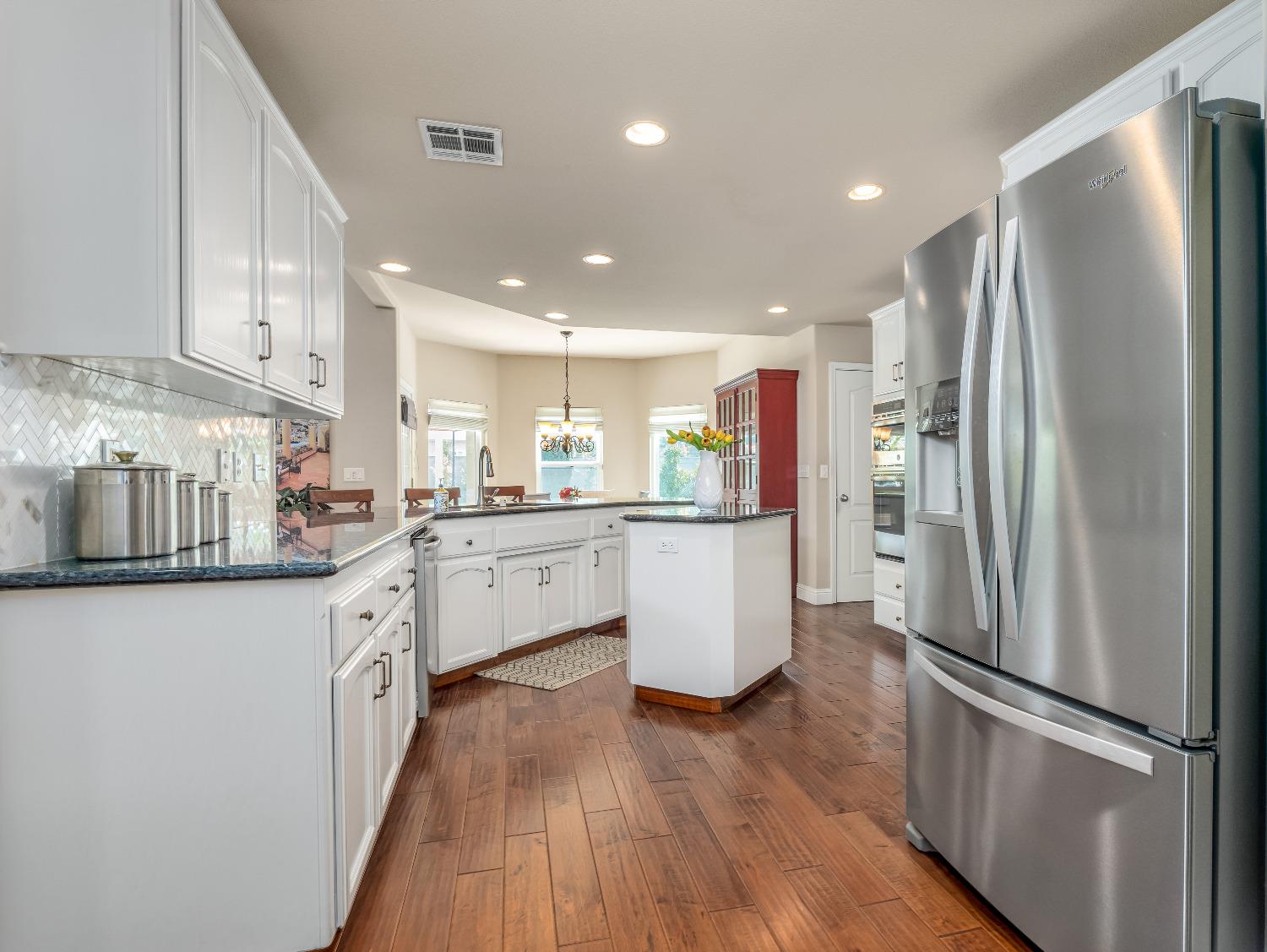 12 Breeze Way Madera, CA 93637 - Photo 13 of 48 a kitchen with stainless steel appliances granite countertop a refrigerator sink and white cabinets