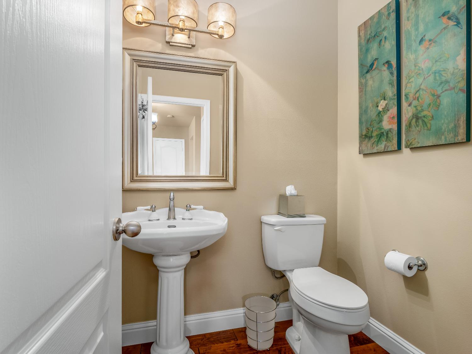 12 Breeze Way Madera, CA 93637 - Photo 17 of 48 a bathroom with a toilet sink and mirror