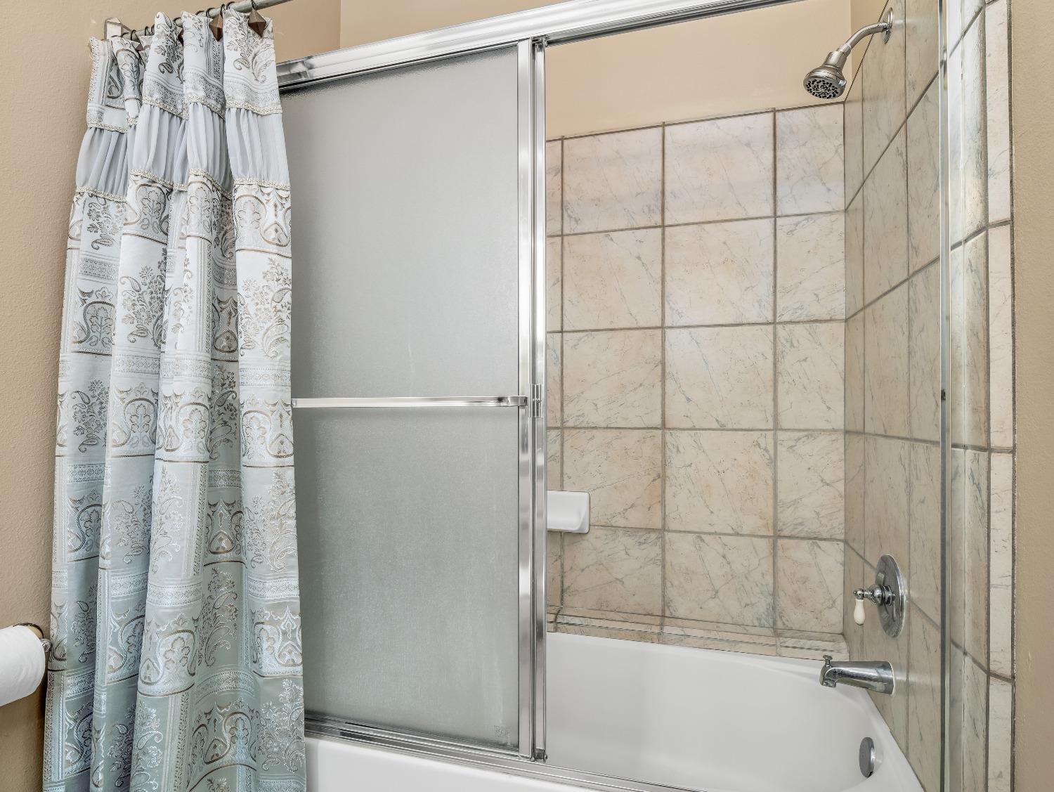 12 Breeze Way Madera, CA 93637 - Photo 21 of 48 a bathroom with a shower and a tub