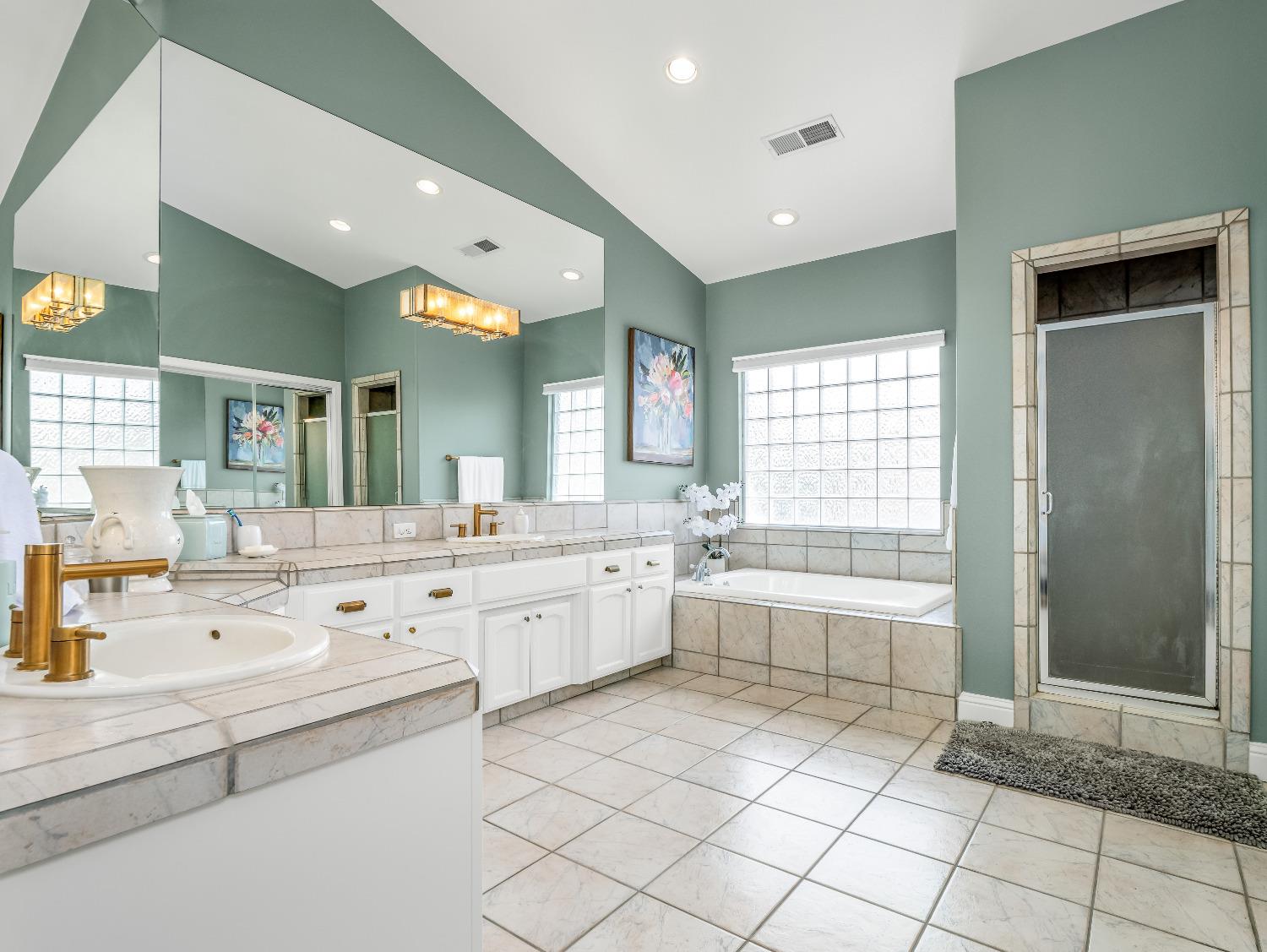 12 Breeze Way Madera, CA 93637 - Photo 27 of 48 a large white bathroom with a large tub sink vanity and granite