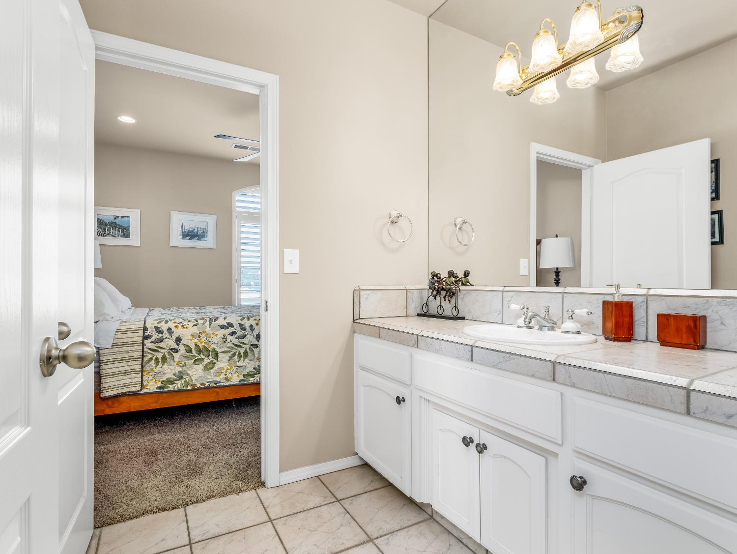 12 Breeze Way Madera, CA 93637 - Photo 36 of 48 a en suite bathroom with double sink and a mirror
