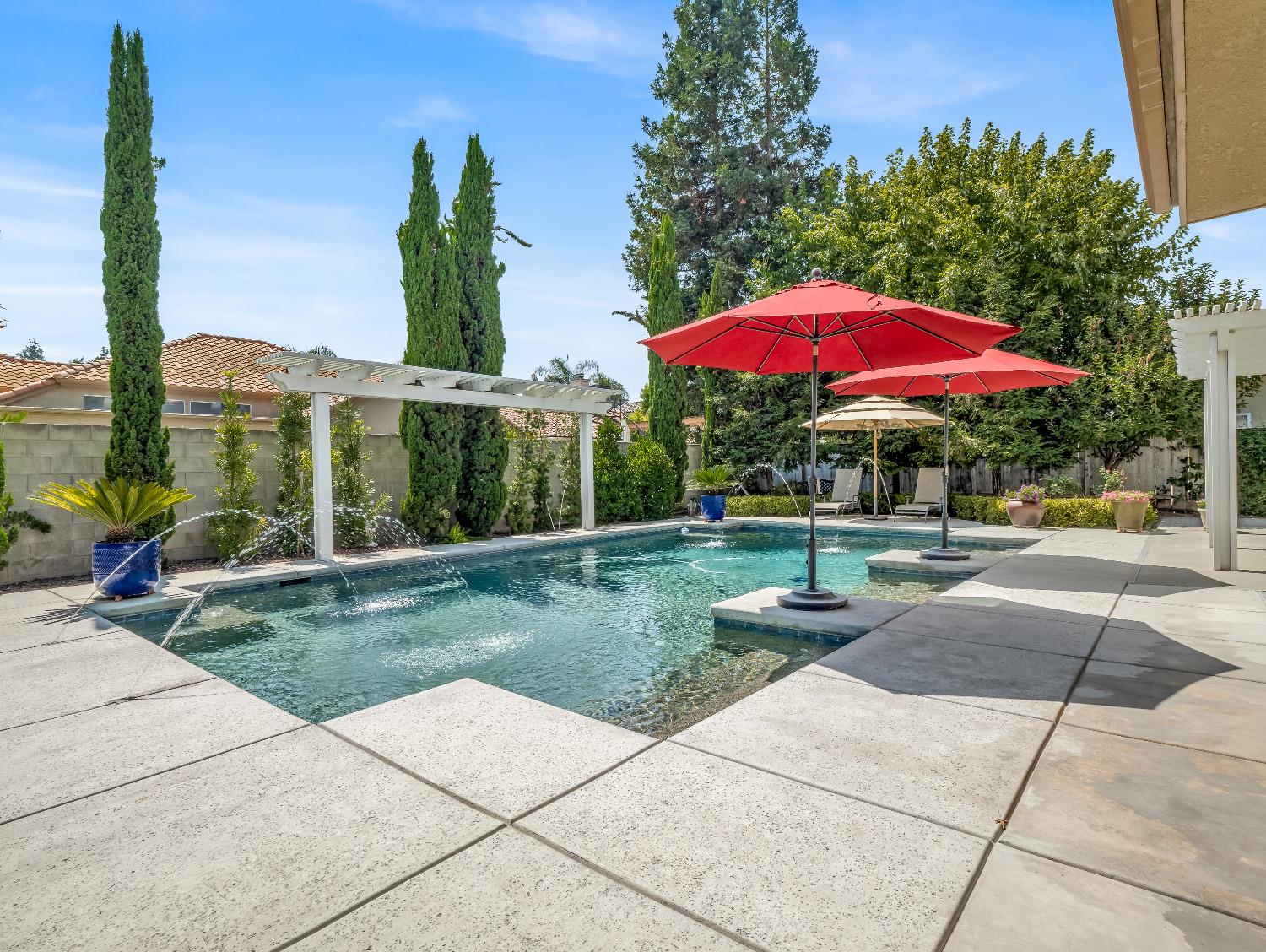 12 Breeze Way Madera, CA 93637 - Photo 42 of 48 a view of a patio with a table and chairs under an umbrella