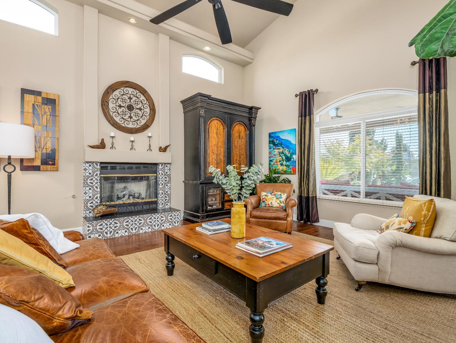 12 Breeze Way Madera, CA 93637 - Photo 8 of 48 a living room with furniture a clock and a fireplace