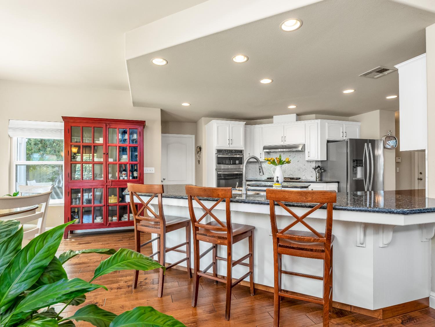 12 Breeze Way Madera, CA 93637 - Photo 9 of 48 a living room with stainless steel appliances kitchen island granite countertop furniture and a dining table with wooden floor