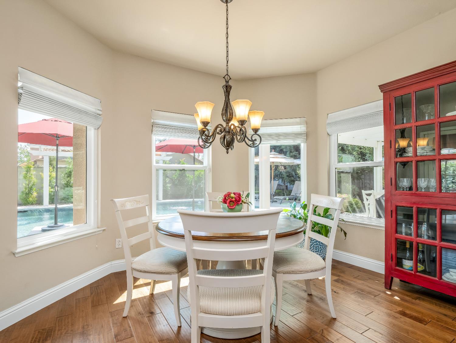 12 Breeze Way Madera, CA 93637 - Photo 10 of 48 a dining room with furniture a chandelier and wooden floor
