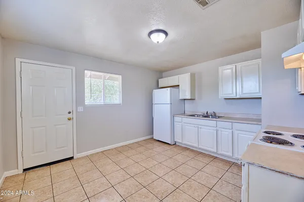 a kitchen with a sink cabinets and appliances