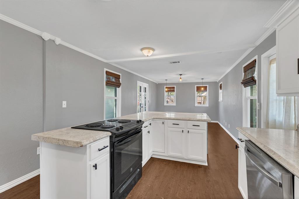 1815 North Riverside Drive Fort Worth, TX 76111 - Photo 11 of 30 Windows light up this kitchen and eating area.