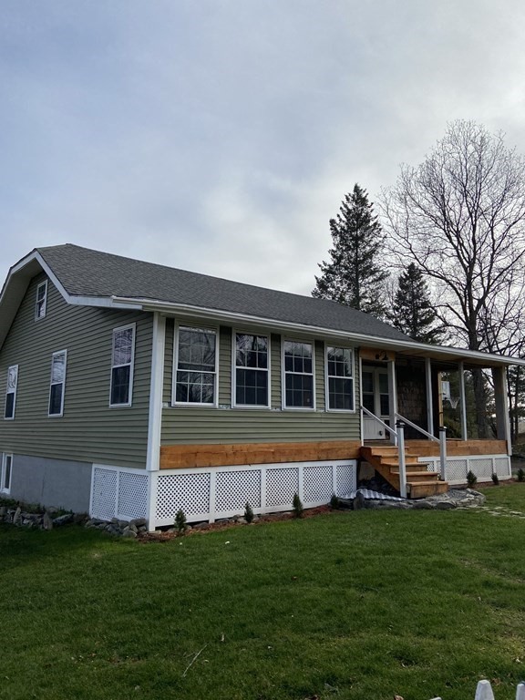 61 Schumacher Road Lancaster, MA 01523 - Photo 3 of 25 a front view of house with yard and green space