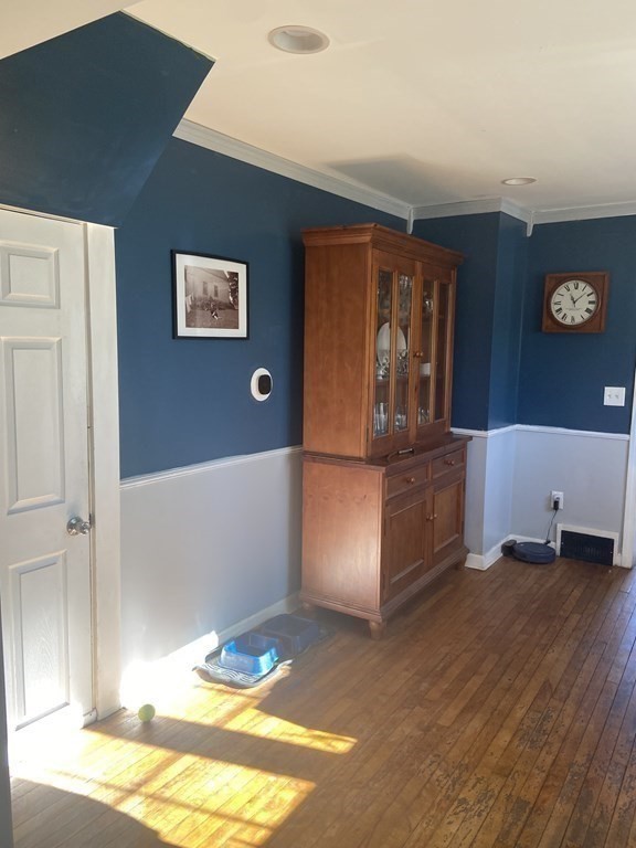 61 Schumacher Road Lancaster, MA 01523 - Photo 6 of 25 a view of a livingroom with wooden floor and kitchen space