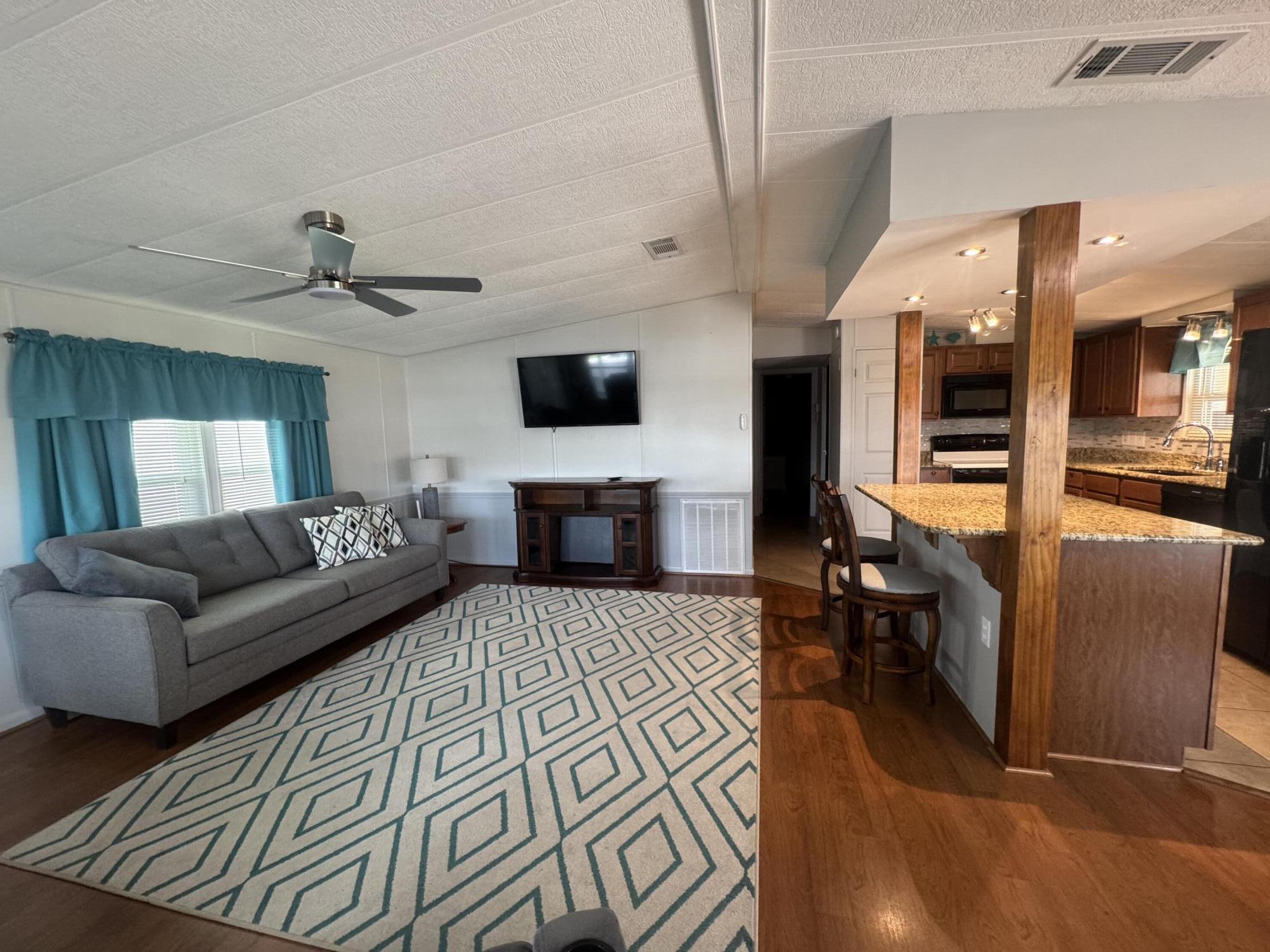 1747 Southwest 35th Circle Okeechobee, FL 34974 - Photo 12 of 21 a living room with furniture and a flat screen tv