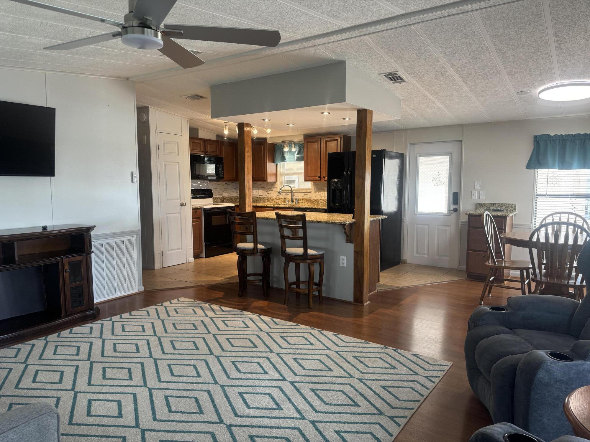 1747 Southwest 35th Circle Okeechobee, FL 34974 - Photo 13 of 21 a living room with furniture and a flat screen tv