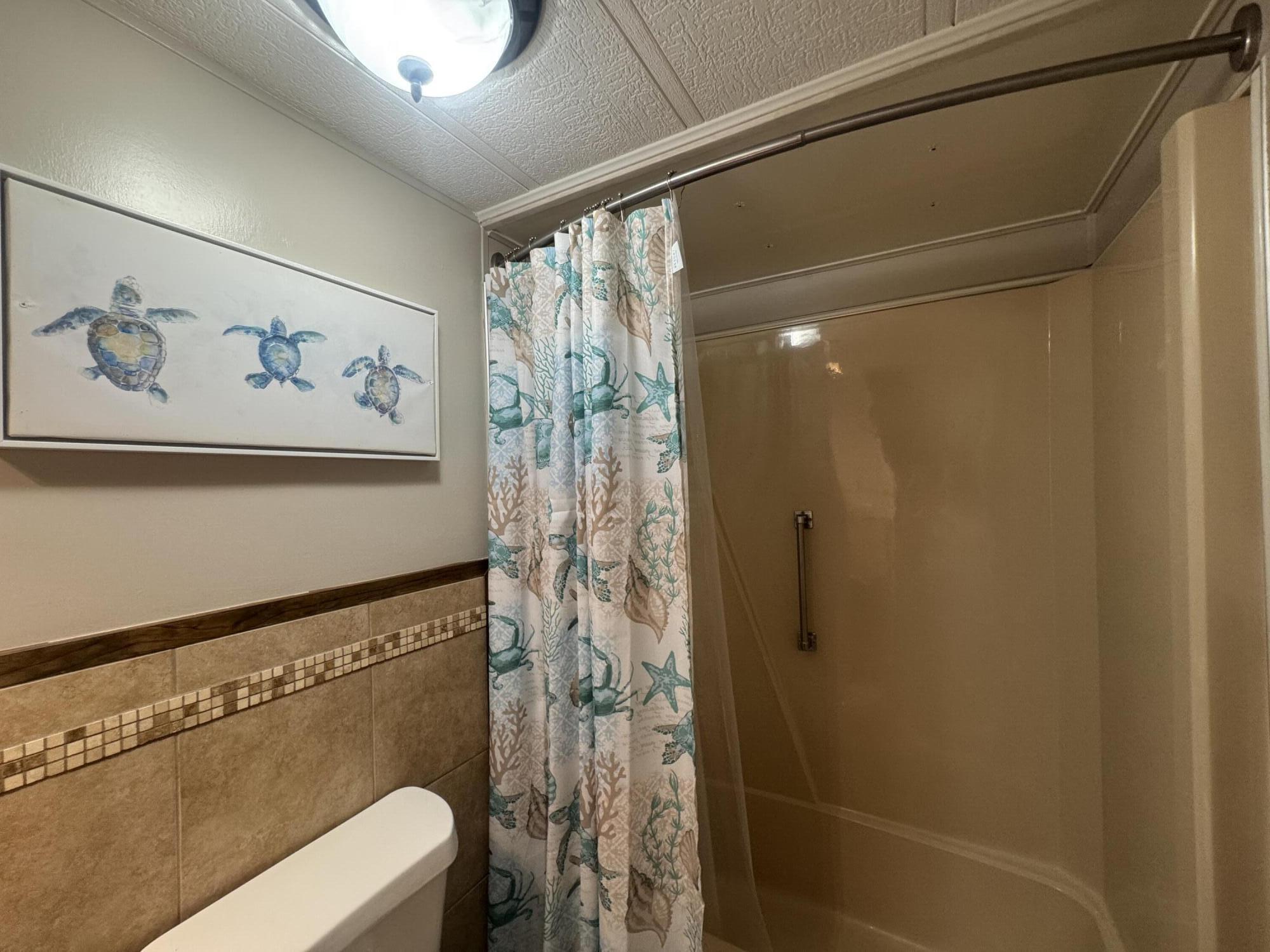 1747 Southwest 35th Circle Okeechobee, FL 34974 - Photo 16 of 21 a bathroom with a shower and a toilet