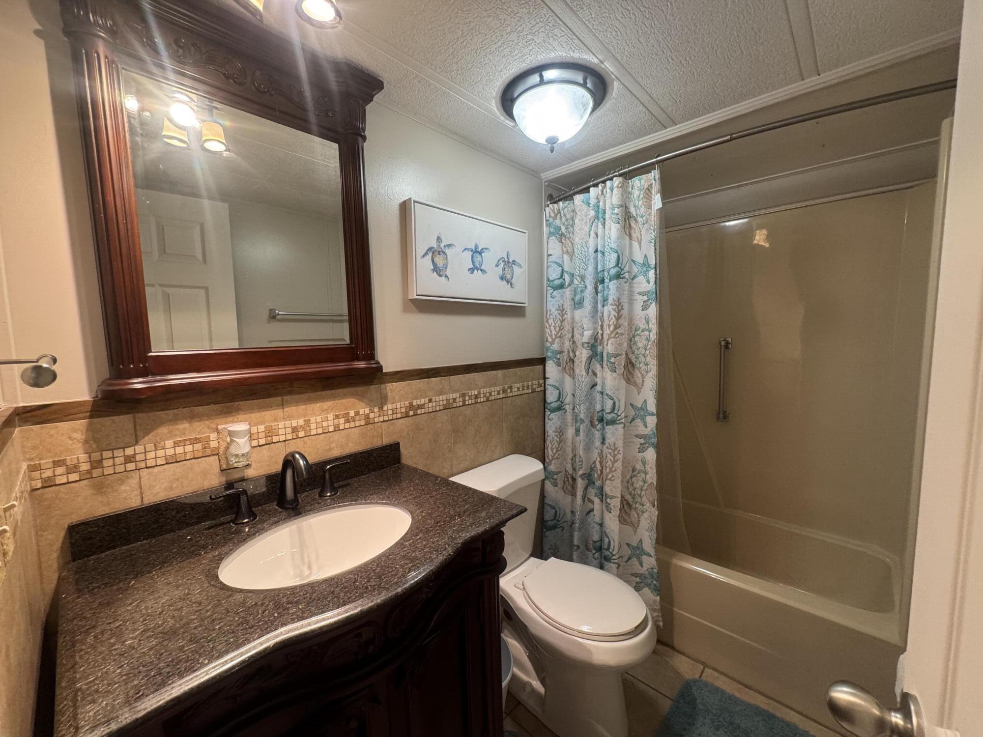 1747 Southwest 35th Circle Okeechobee, FL 34974 - Photo 17 of 21 a bathroom with a sink a toilet and shower