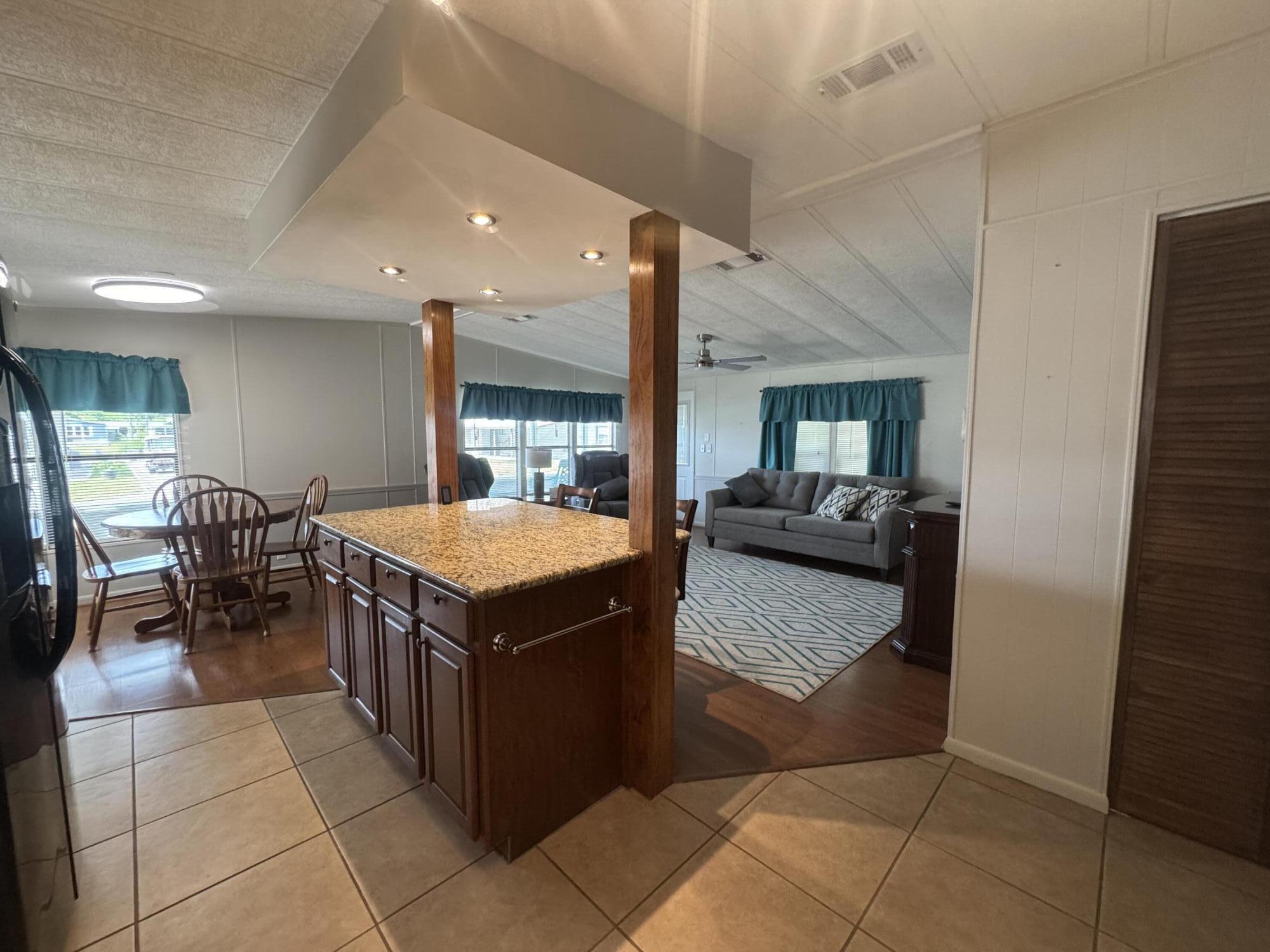 1747 Southwest 35th Circle Okeechobee, FL 34974 - Photo 9 of 21 a kitchen with stainless steel appliances granite countertop a stove and a refrigerator