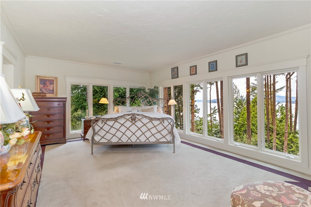 764 Big Foot Road Friday Harbor, WA 98250 - Photo 13 of 34 a bedroom with furniture and a large window