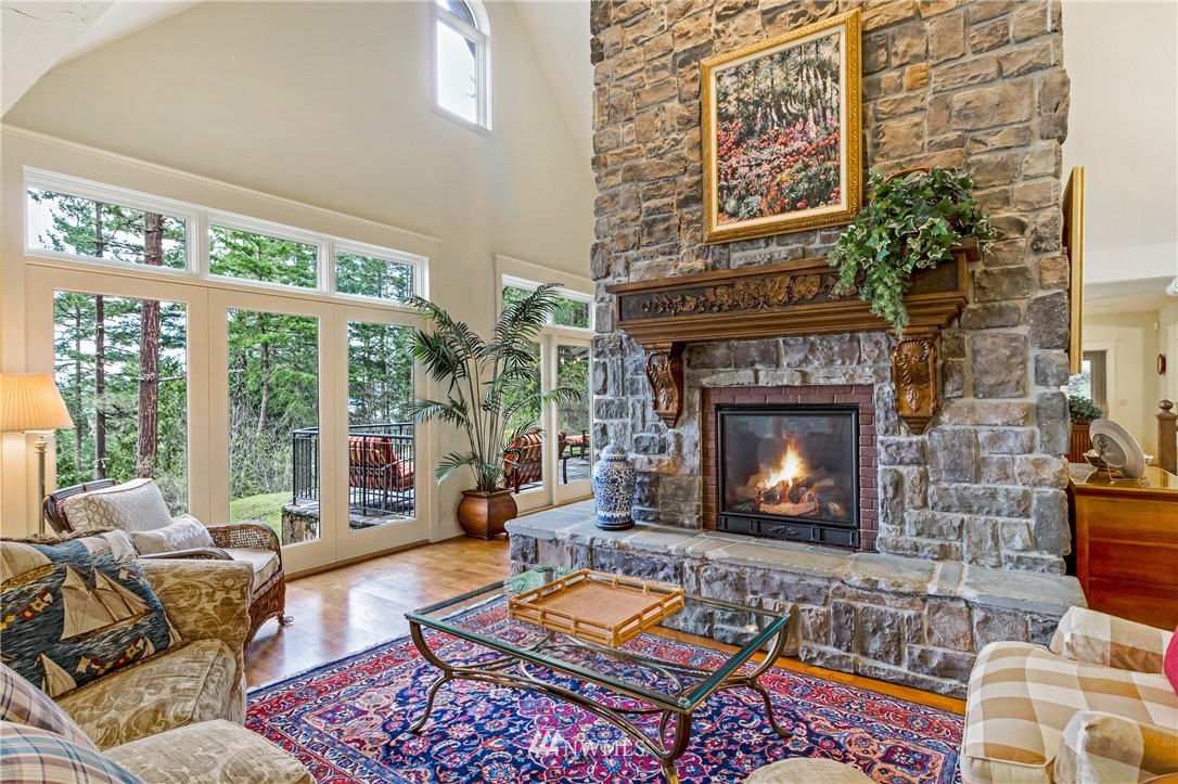 764 Big Foot Road Friday Harbor, WA 98250 - Photo 3 of 34 a living room with furniture a fireplace and a large window