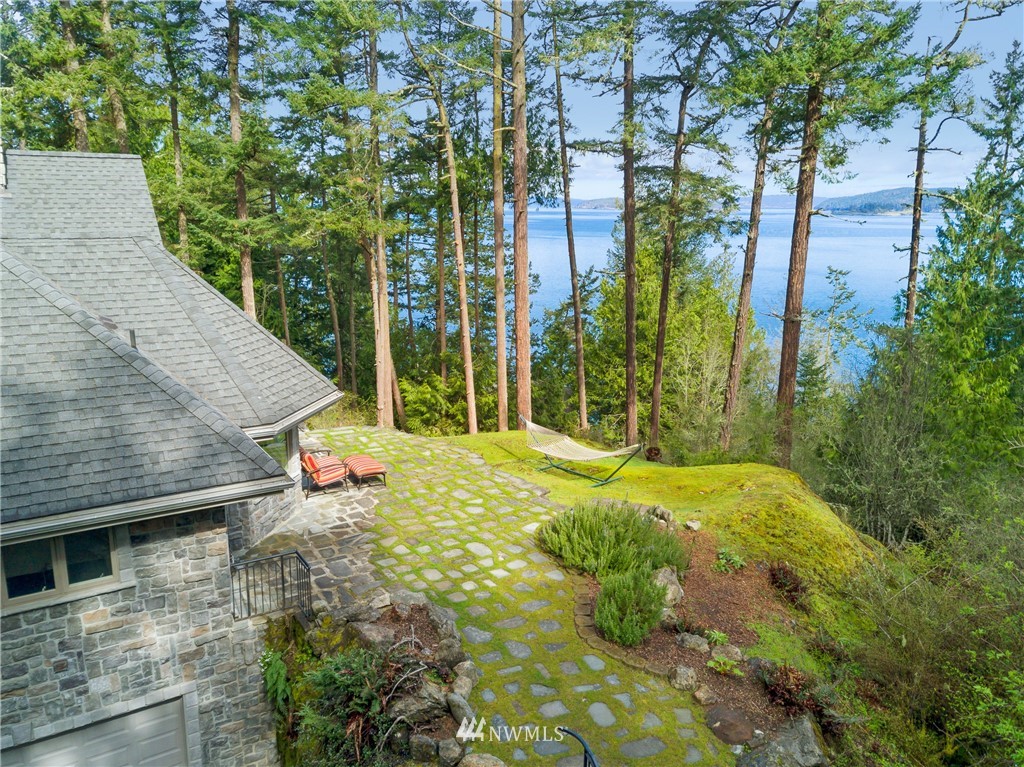 764 Big Foot Road Friday Harbor, WA 98250 - Photo 26 of 34 a view of a backyard with plants and brick wall