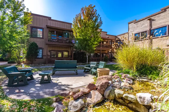 a view of a house with backyard sitting area and garden