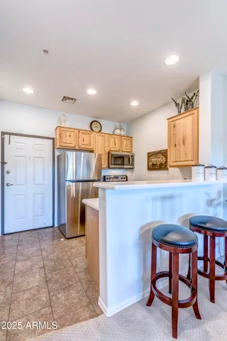 a view of a porch with a floor to ceiling window and potted plants