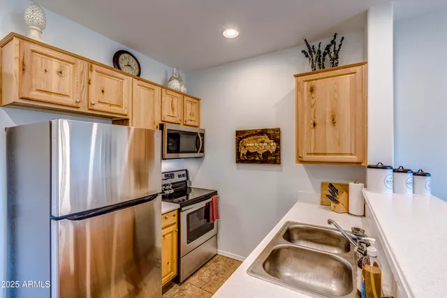 a view of a back yard of the house with a patio