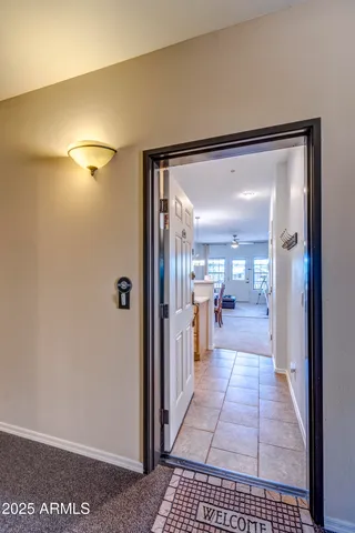 a view of a house with a barbeque and large trees