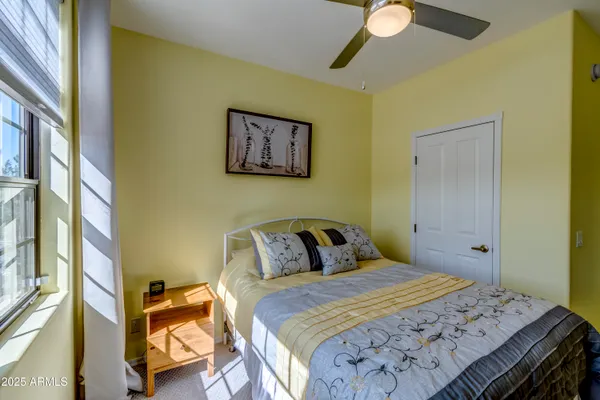 a bedroom with a bed and a painting on the wall