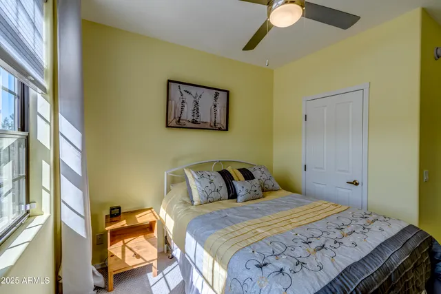 a bedroom with a bed and a painting on the wall