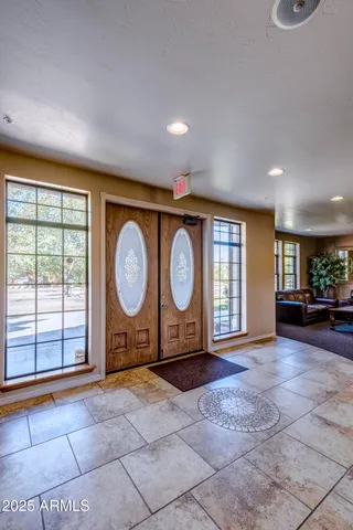 a view of a house with a yard and palm trees