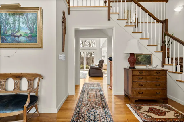 a view of entryway and hall with wooden floor