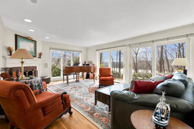 a living room with furniture and a floor to ceiling window
