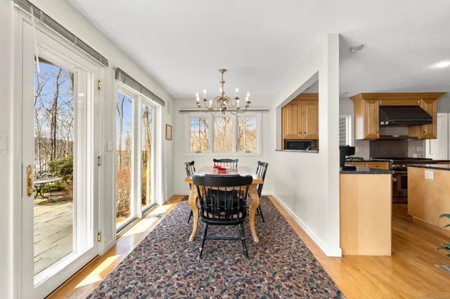 a kitchen with kitchen island granite countertop wooden floors and wooden cabinets