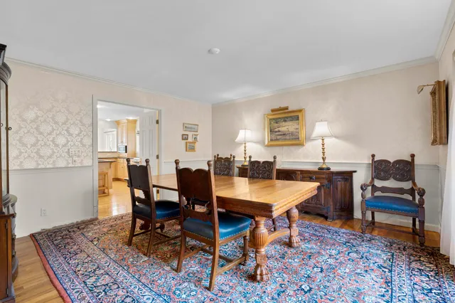 a view of a hallway with wooden floor and windows