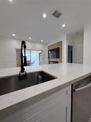 a kitchen with a sink and a refrigerator