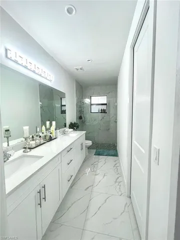 a bathroom with a double vanity sink and mirror