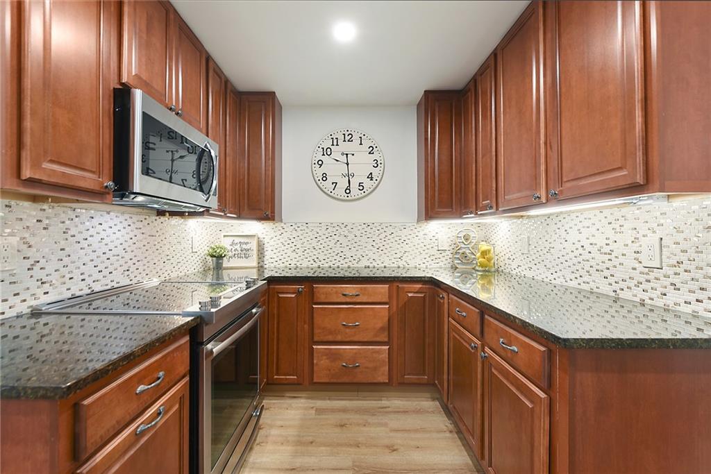3316 Ivanhoe Road Pittsburgh, PA 15241 - Photo 11 of 37 a kitchen with stainless steel appliances granite countertop a sink stove and cabinets
