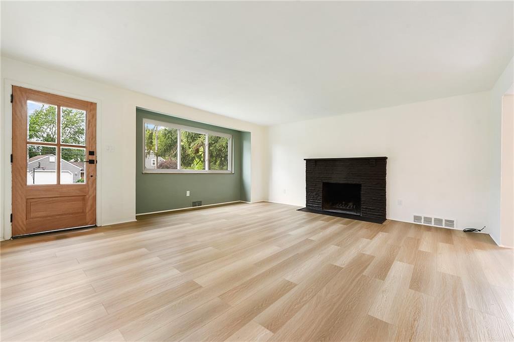 3316 Ivanhoe Road Pittsburgh, PA 15241 - Photo 3 of 37 an empty room with a fireplace and windows