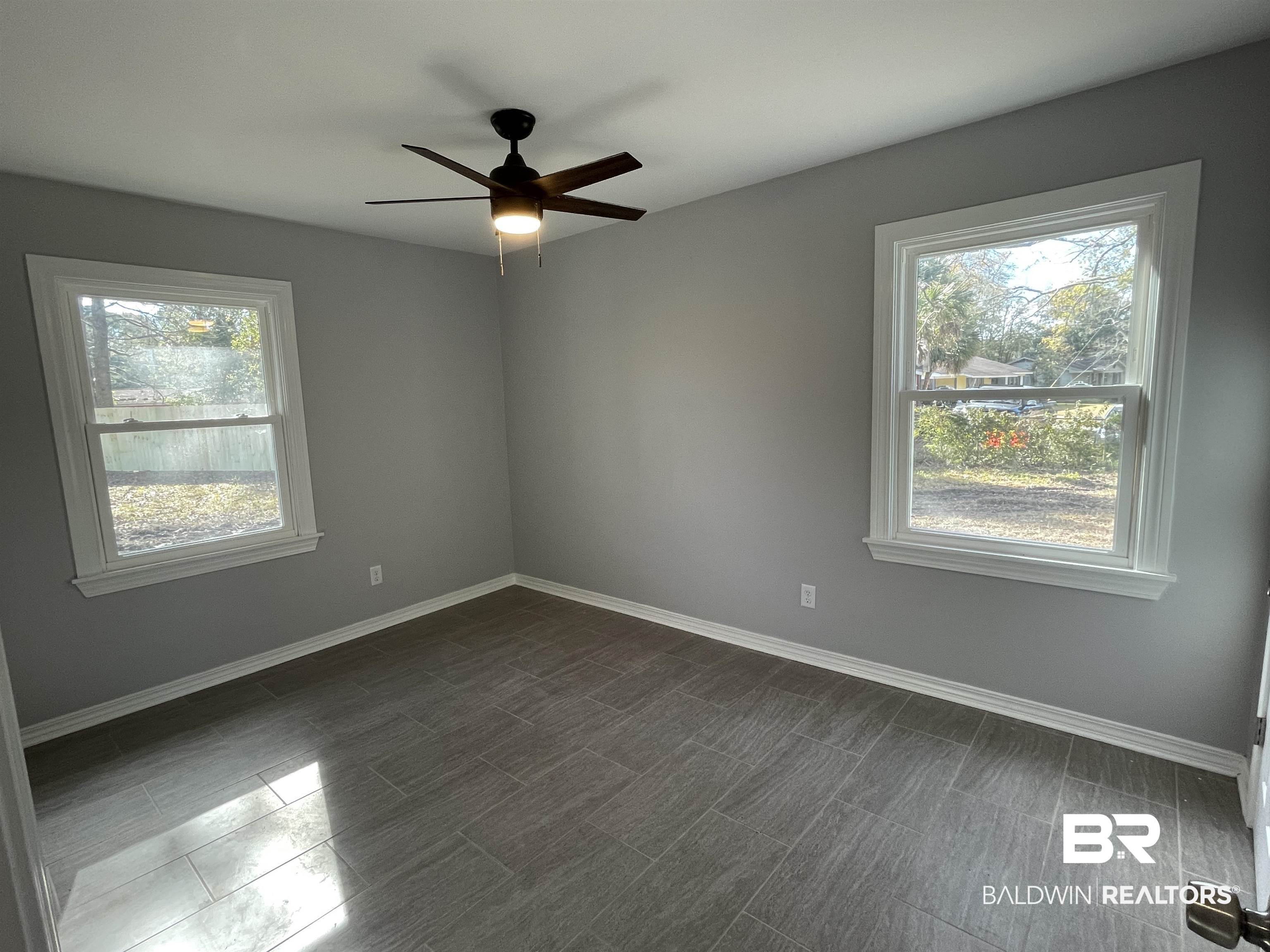 3901 Prima Vera Lane Mobile, AL 36605 - Photo 4 of 15 Spare room with a wealth of natural light and ceiling fan