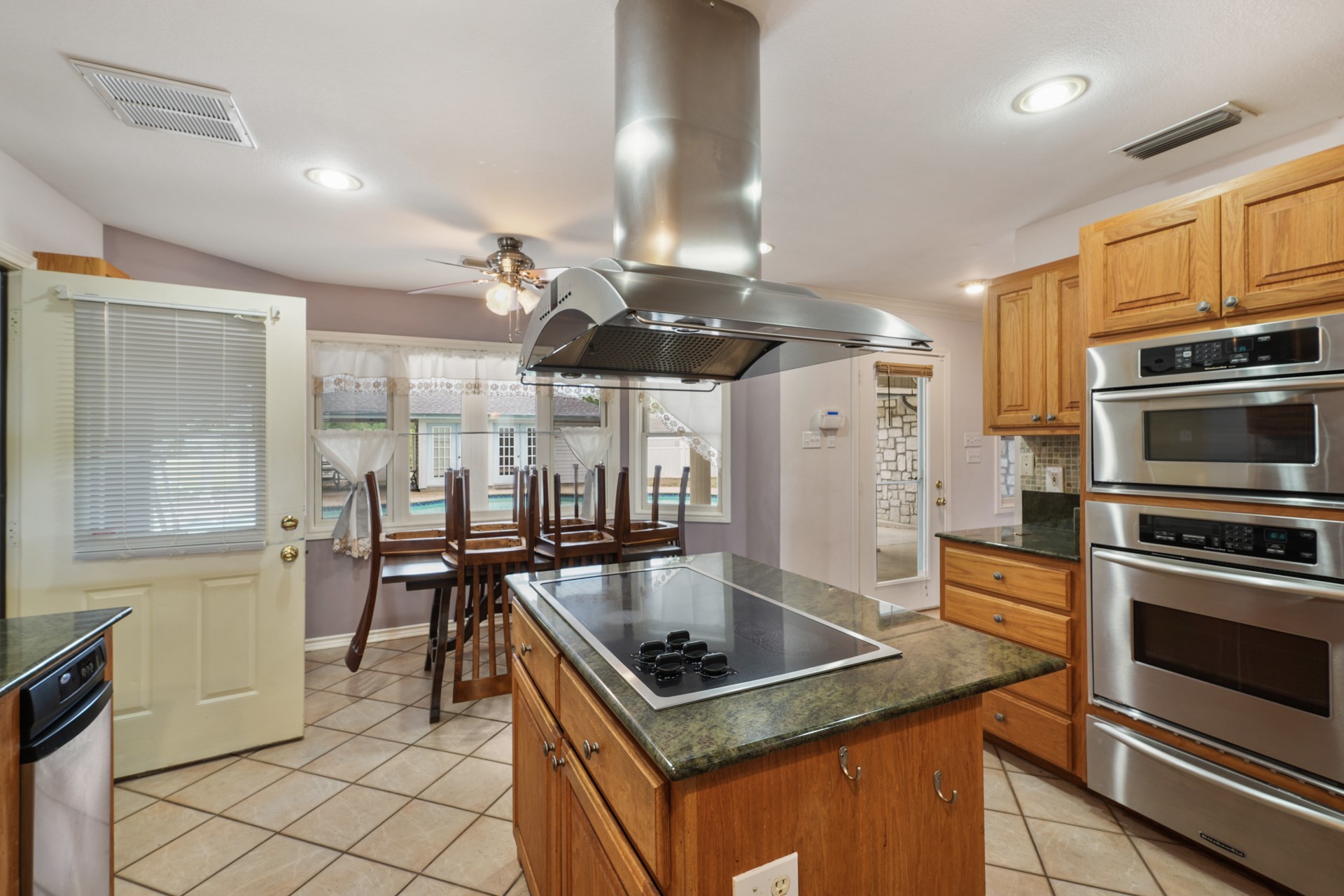 6625 East Post Road Kyle, TX 78640 - Photo 13 of 46 a kitchen with stainless steel appliances granite countertop a sink stove and refrigerator