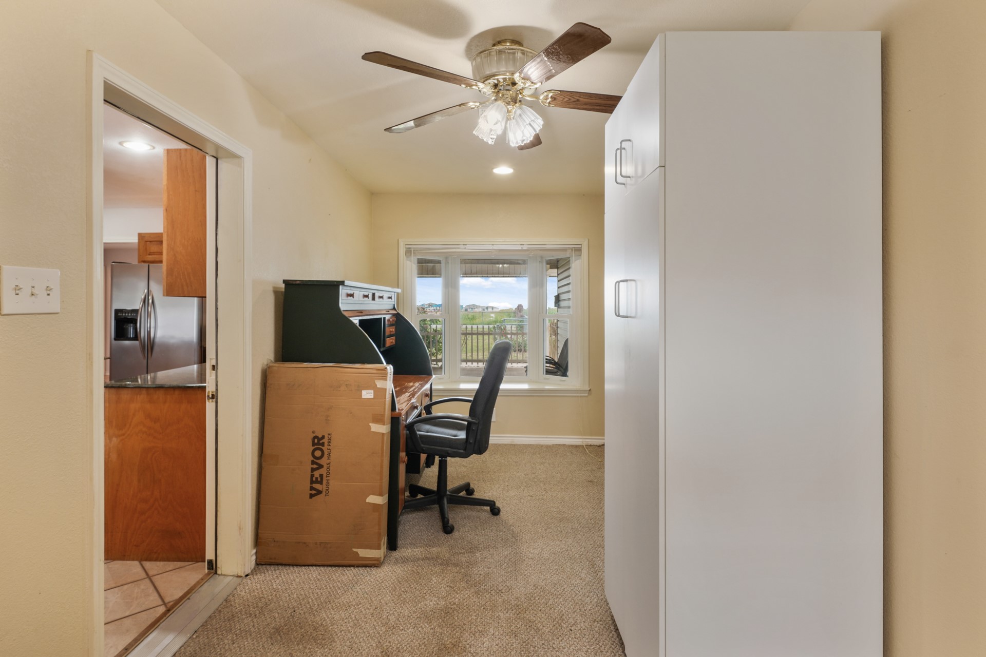 6625 East Post Road Kyle, TX 78640 - Photo 14 of 46 a work room with furniture and a chandelier fan