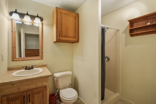 a view of an empty room with a ceiling fan