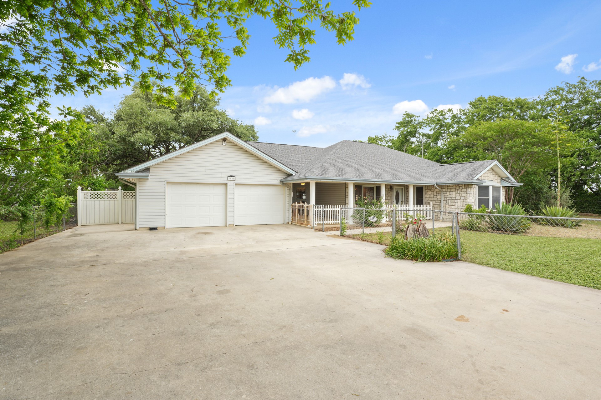 6625 East Post Road Kyle, TX 78640 - Photo 2 of 46 a front view of a house with a garden and porch
