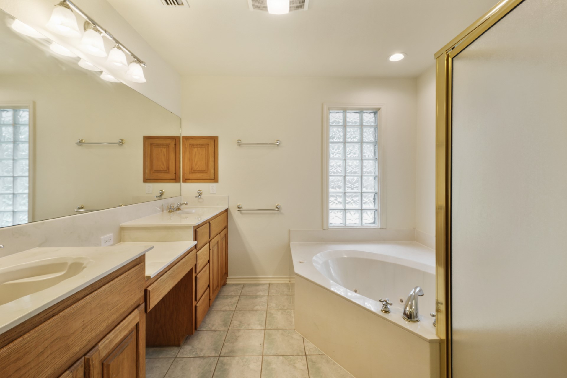 6625 East Post Road Kyle, TX 78640 - Photo 21 of 46 a spacious bathroom with a granite countertop tub sink and mirror