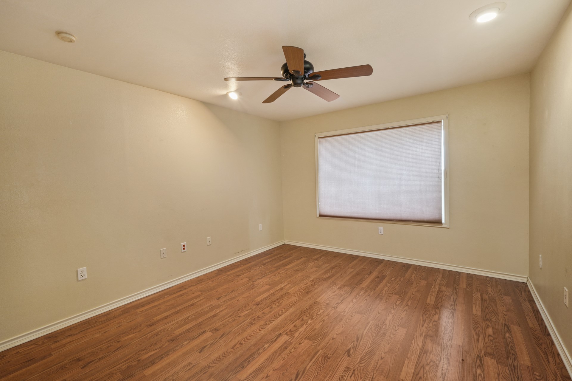 6625 East Post Road Kyle, TX 78640 - Photo 23 of 46 a view of an empty room with wooden floor and a ceiling fan